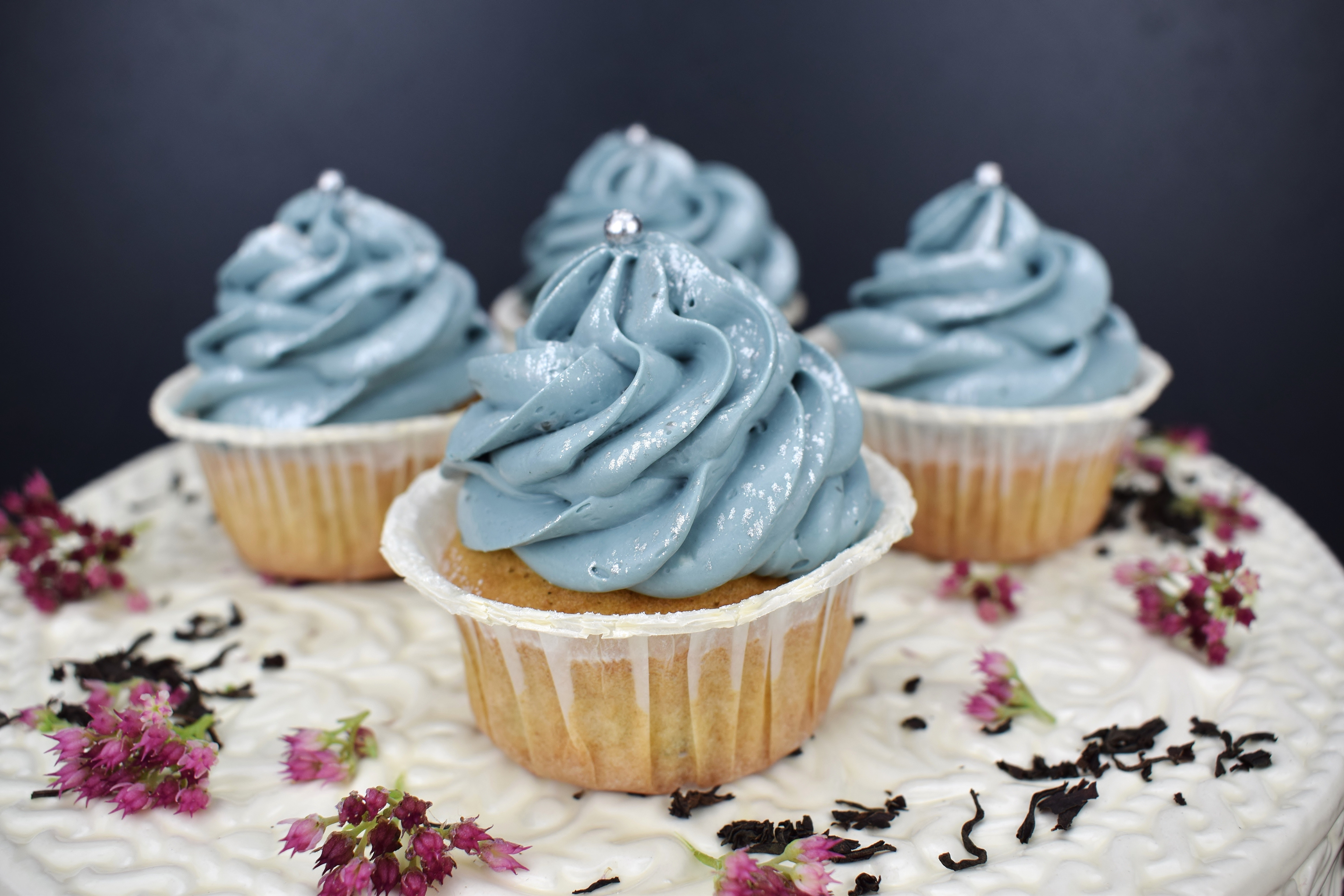 Four cup cakes with blu cream